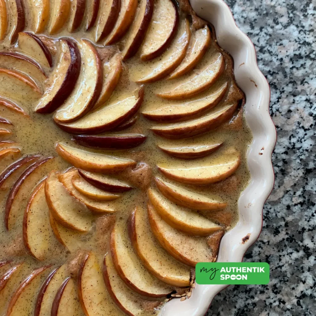 high protein apple clafoutis fresh out of the oven with golden baked apple slices