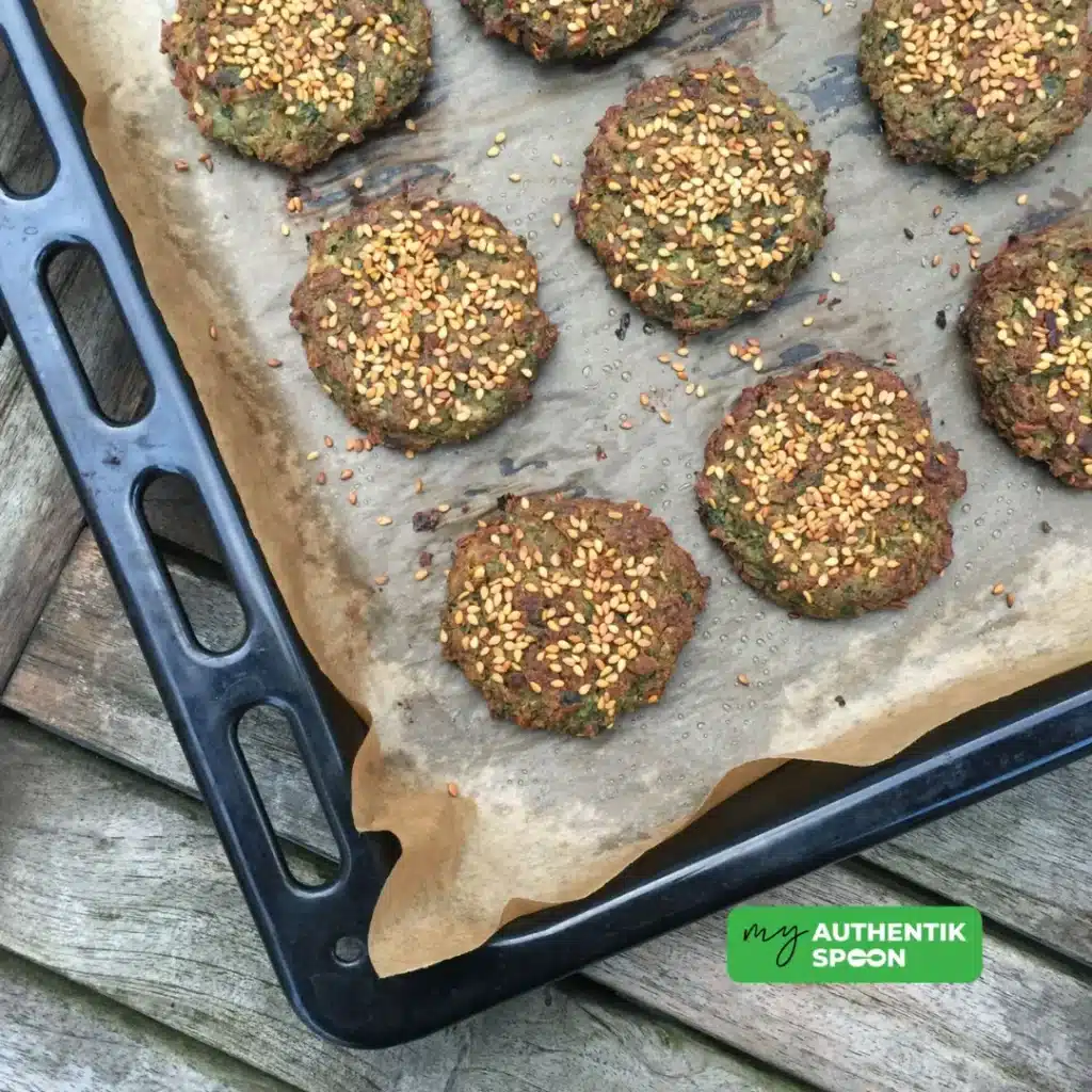 plated baked falafel with golden sesame seeds and bite taken