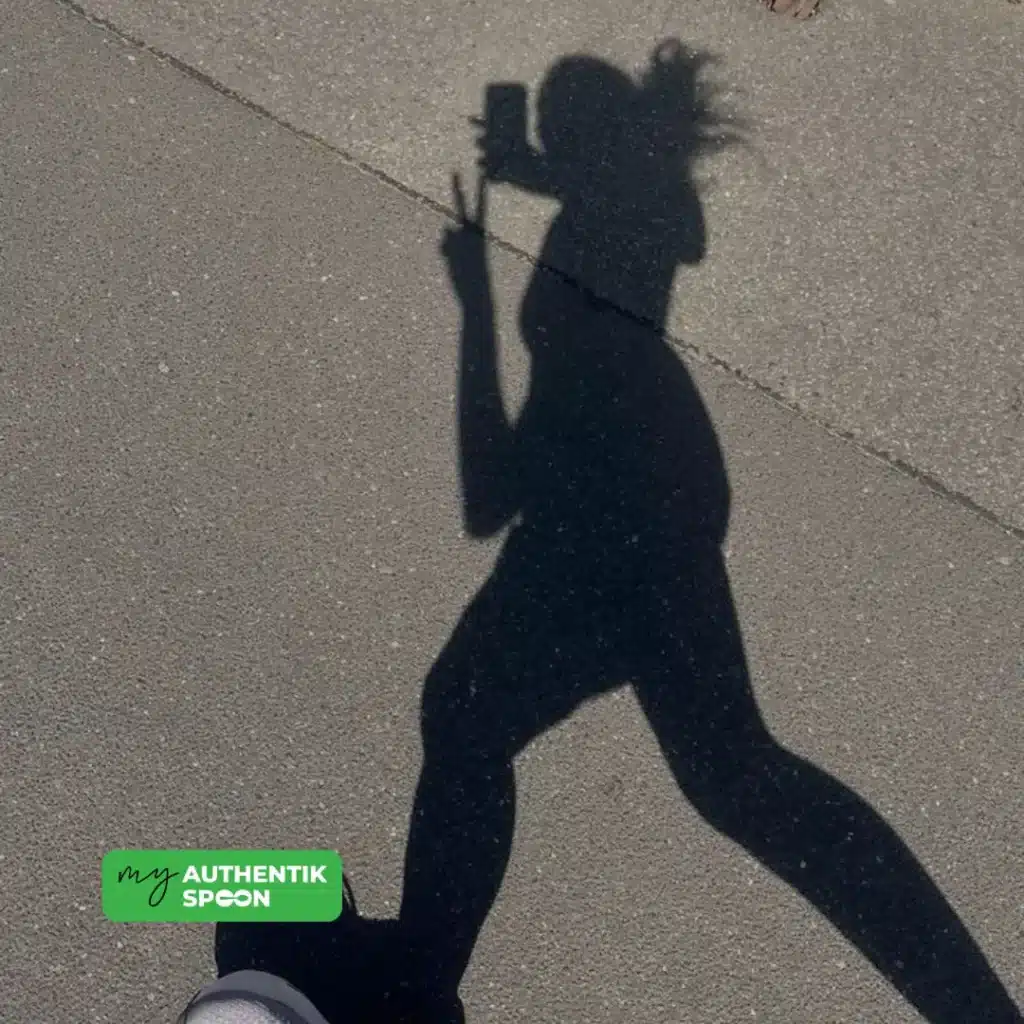 shadow of a woman walking outdoors in the early morning light