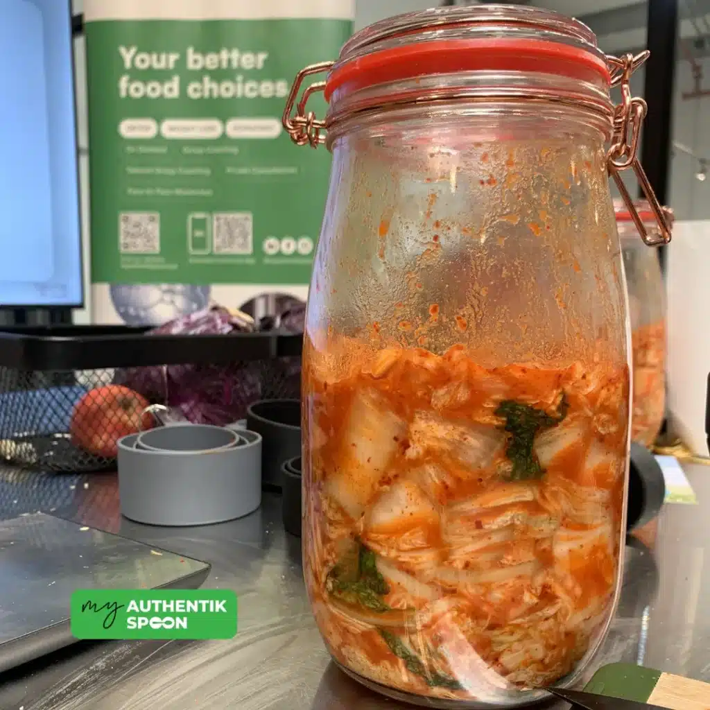 Fermented foods for sugar cravings shown as a jar of homemade kimchi on a kitchen counter, supporting gut health, digestion, and energy.