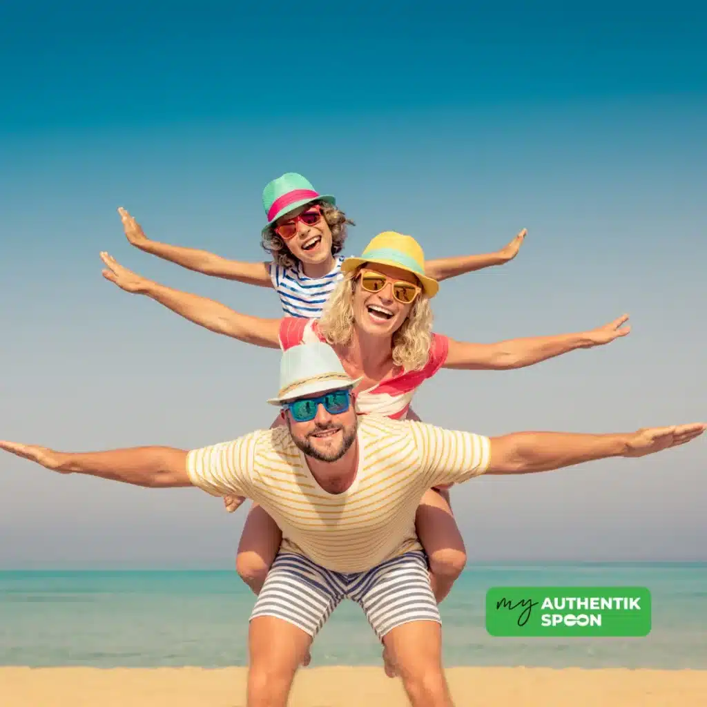 Smiling family enjoying healthy summer habits on the beach, showing playful movement and energy under the sun