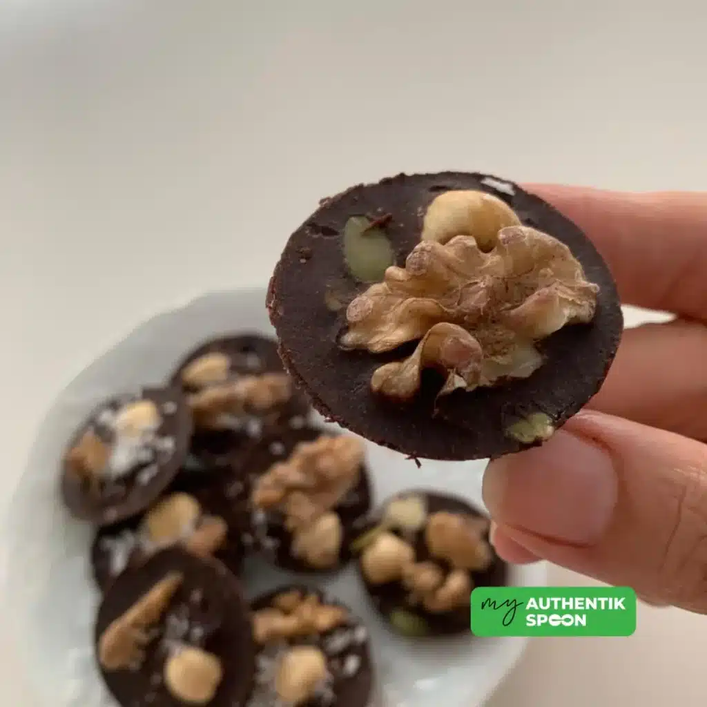 Healthy chocolate bites topped with walnuts and nuts for healthy fats and satisfaction
