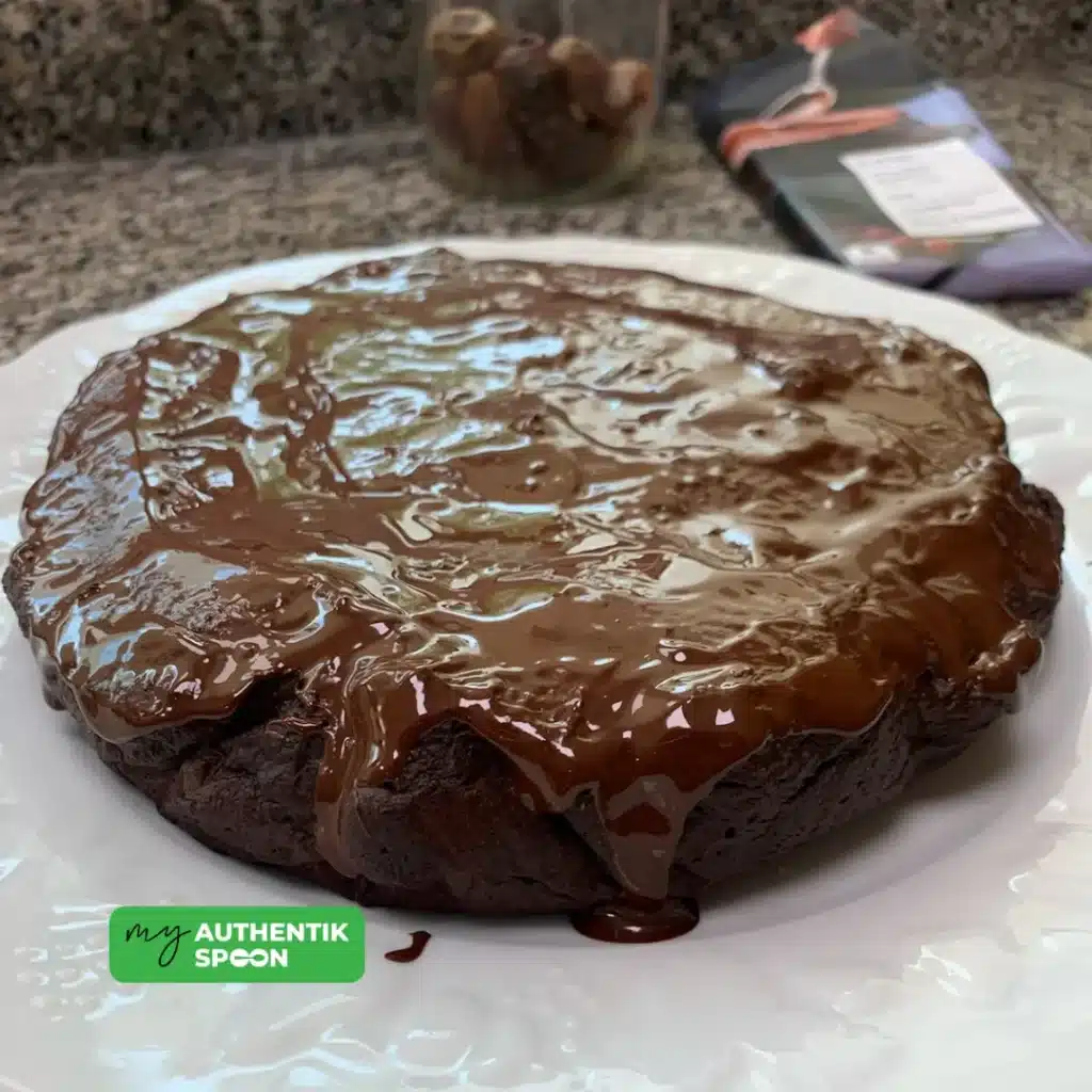 Chocolate date cake with glossy dark chocolate topping rich gluten-free homemade dessert