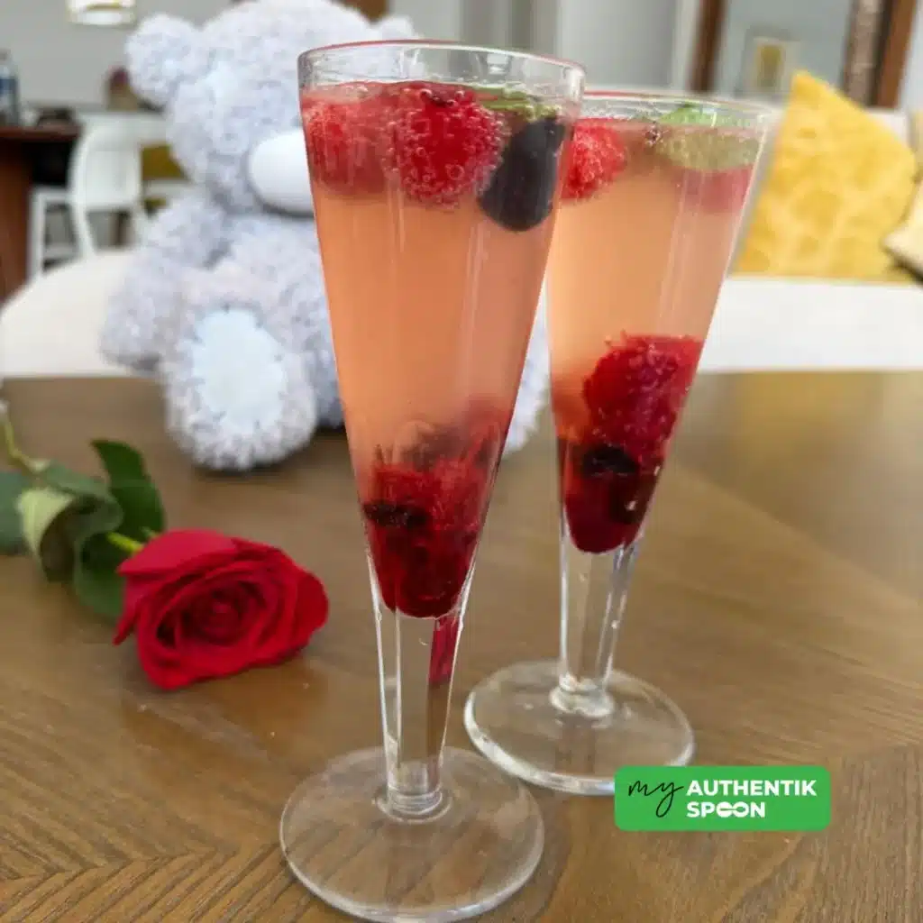 Kombucha Valentine mocktail with raspberries and berries in tall glasses, romantic alcohol-free drink for gut-friendly celebration