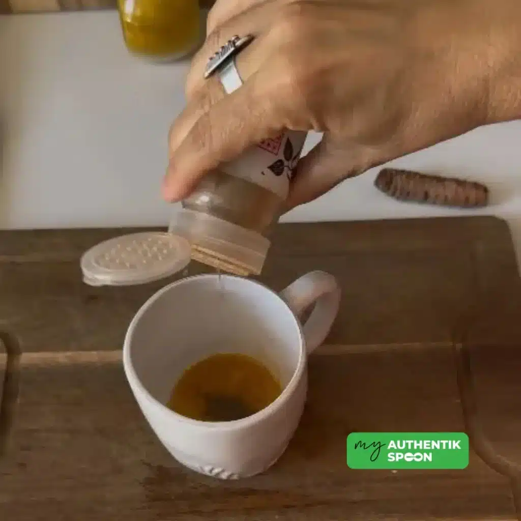 Adding anti-inflammatory spices like turmeric and black pepper to a digestive morning drink.