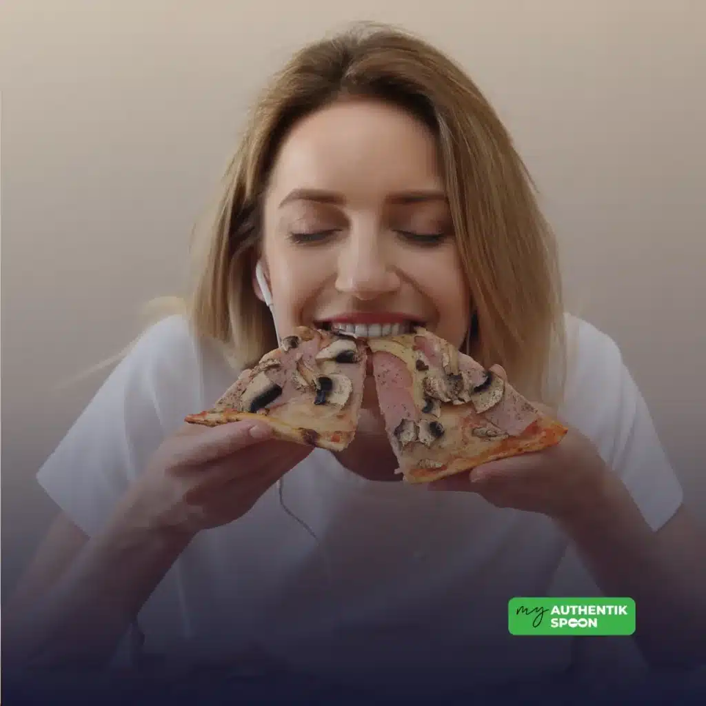 woman eating pizza with strong food cravings illustrating sugar cravings and blood sugar imbalance