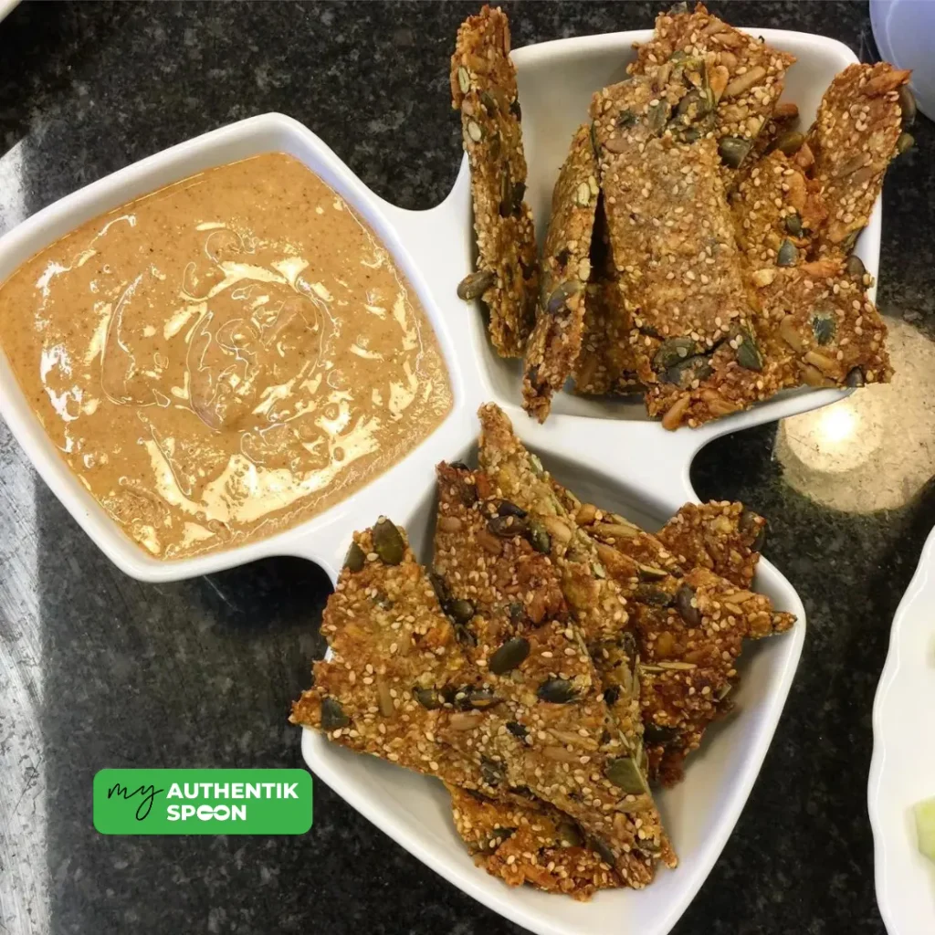 gluten free crackers with pumpkin, sunflower and sesame seeds served with a creamy dip