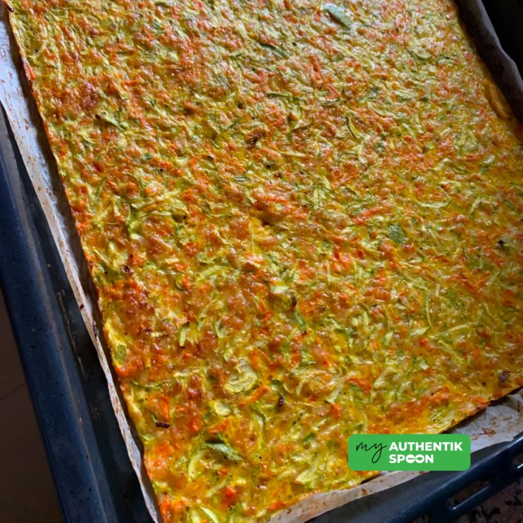 Zucchini and carrot flatbread baked in a large lined oven tray