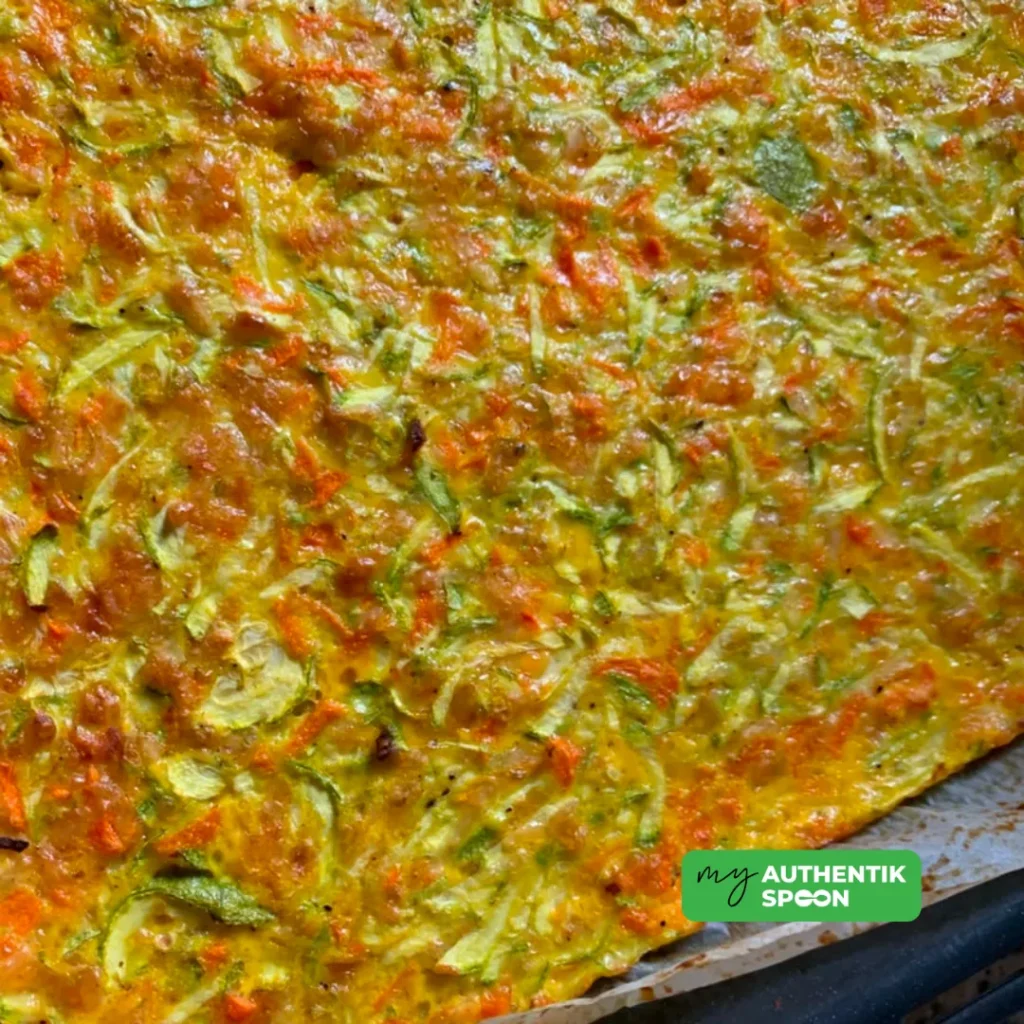 Healthy vegetable flatbread recipe made with grated zucchini, carrots, eggs and cheddar