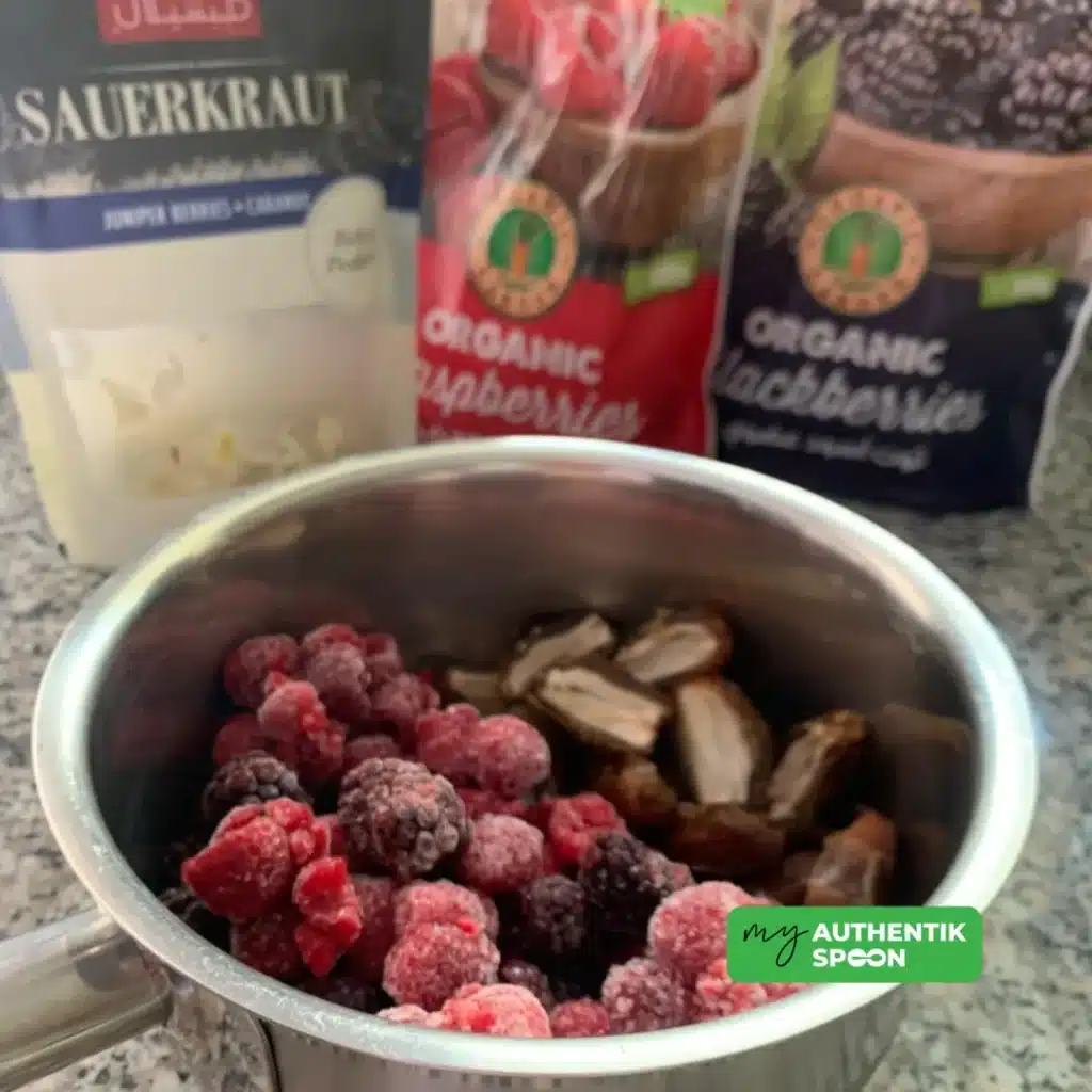 Ingredients for lacto-fermented berries jam with mixed berries, dates and fermented brine to support gut health and reduce sugar cravings